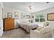 Cozy bedroom with natural light, ceiling fan, plush carpet and charming decor for a relaxing retreat at 25312 E Lenox Cir, Punta Gorda, FL 33950