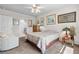 Well-lit bedroom with plush carpeting, ceiling fan, bright window and access to ensuite bathroom at 25312 E Lenox Cir, Punta Gorda, FL 33950