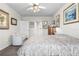 Spacious bedroom with soft carpet, ceiling fan, neutral colors, and access to private ensuite at 25312 E Lenox Cir, Punta Gorda, FL 33950