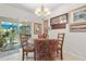 Eat-in dining area with chandelier, a collection of wall art, and sliding glass door access to the lanai at 25312 E Lenox Cir, Punta Gorda, FL 33950