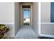 Close-up shot of the well-lit front door and adjacent manicured garden at 25312 E Lenox Cir, Punta Gorda, FL 33950