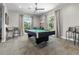 Community game room with a billiard table, seating, and natural light for entertainment and relaxation at 25312 E Lenox Cir, Punta Gorda, FL 33950