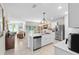 Open kitchen with stainless steel appliances, an island with a sink, and modern lighting at 25312 E Lenox Cir, Punta Gorda, FL 33950