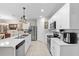 The kitchen features stainless appliances, white cabinets and tiled flooring at 25312 E Lenox Cir, Punta Gorda, FL 33950