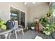 Relaxing screened lanai with a glass table, potted plants and ceiling fan for outdoor comfort at 25312 E Lenox Cir, Punta Gorda, FL 33950