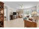 Bright living room with tile floors, ceiling fan, plenty of natural light, and comfortable seating at 25312 E Lenox Cir, Punta Gorda, FL 33950