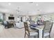 Open concept living room features modern décor, comfortable seating and adjoins kitchen and dining area at 25312 E Lenox Cir, Punta Gorda, FL 33950