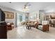 Comfortable living room features neutral paint, ceiling fan, tile floors and access to dining room at 25312 E Lenox Cir, Punta Gorda, FL 33950