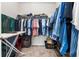 Bright walk-in closet with extensive shelving, hanging rods, an ironing board, and safe storage at 25312 E Lenox Cir, Punta Gorda, FL 33950