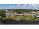 Property features canal access with dock, palm trees, spacious yard, and residential street access at 27193 And 27197 Voyageur Dr, Punta Gorda, FL 33983