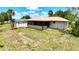 Home with screened lanai, a shed, and a lawn backing to a canal at 27193 And 27197 Voyageur Dr, Punta Gorda, FL 33983