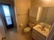 Well-lit bathroom with convenient access to the exterior and a modern sink at 27193 And 27197 Voyageur Dr, Punta Gorda, FL 33983