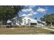 Exterior view of the community building featuring well-maintained landscaping and convenient accessible parking at 27193 And 27197 Voyageur Dr, Punta Gorda, FL 33983