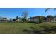 Single story home boasts a well-maintained lawn and water access, situated in a quiet residential neighborhood at 27193 And 27197 Voyageur Dr, Punta Gorda, FL 33983