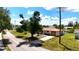 Well-maintained home with a long driveway and lush greenery, located on a quiet street at 27193 And 27197 Voyageur Dr, Punta Gorda, FL 33983