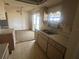 Bright kitchen with a double sink and ample cabinet space, conveniently located near the dining area at 27193 And 27197 Voyageur Dr, Punta Gorda, FL 33983