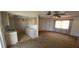 Open-concept living area with a ceiling fan and ample natural light, adjacent to the kitchen at 27193 And 27197 Voyageur Dr, Punta Gorda, FL 33983
