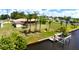 Waterfront home with a boat dock and lush palm trees, situated on a picturesque canal at 27193 And 27197 Voyageur Dr, Punta Gorda, FL 33983