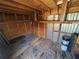 A shed with wood flooring, wood walls and ceiling with a built-in shelf for extra storage at 27193 And 27197 Voyageur Dr, Punta Gorda, FL 33983