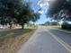 A quiet street view in a neighborhood featuring mature landscaping at 27193 And 27197 Voyageur Dr, Punta Gorda, FL 33983