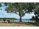 Beautiful waterfront view with picnic table and mature shade trees create a relaxing atmosphere at 27193 And 27197 Voyageur Dr, Punta Gorda, FL 33983
