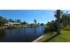 Scenic view from the waterfront featuring docks and serene water reflecting the clear blue sky at 27193 And 27197 Voyageur Dr, Punta Gorda, FL 33983