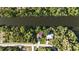 Aerial view of a home with a brown roof next to a river and a treeline at 2955 Carmela Ave, North Port, FL 34286