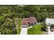 Aerial view of a single-story home nestled on a lot with mature landscaping and water views at 2955 Carmela Ave, North Port, FL 34286
