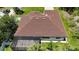 Bird's eye view of the house's roof, screened in patio, and surrounding landscape at 2955 Carmela Ave, North Port, FL 34286