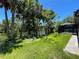 A backyard view including trees, screened lanai, and canal access at 2955 Carmela Ave, North Port, FL 34286