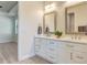 Bright bathroom featuring double vanity with quartz countertops and stylish framed mirrors at 2955 Carmela Ave, North Port, FL 34286
