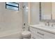 Well-lit bathroom featuring a bathtub, shower, and a modern vanity at 2955 Carmela Ave, North Port, FL 34286
