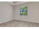 Inviting bedroom showcasing wood-look tile flooring and a bright window at 2955 Carmela Ave, North Port, FL 34286