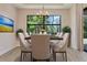 Dining room with large window, modern chandelier, and seating for eight at 2955 Carmela Ave, North Port, FL 34286