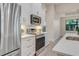 Modern kitchen featuring stainless steel appliances, white cabinets, and sleek countertops at 2955 Carmela Ave, North Port, FL 34286