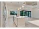 Bright, open kitchen featuring a large island with quartz countertops, stainless appliances, and pendant lighting at 2955 Carmela Ave, North Port, FL 34286