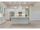 Bright kitchen with white cabinets, stainless steel appliances, and a large center island at 2955 Carmela Ave, North Port, FL 34286