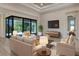 Bright living room with neutral walls, sliding glass doors, and recessed lighting at 2955 Carmela Ave, North Port, FL 34286