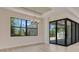 Living area features a large window, sliding glass doors, and an abundance of natural light at 2955 Carmela Ave, North Port, FL 34286