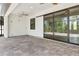 Spacious outdoor patio with tiled flooring, ceiling fans and sliding glass doors at 2955 Carmela Ave, North Port, FL 34286