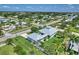 This aerial view showcases the home's landscaping, garage, and location in a quiet residential neighborhood at 329 W Grace St, Punta Gorda, FL 33950