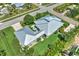 Aerial view of the property showing the house, metal roof, green lawn, driveway, mature landscaping, and surrounding neighborhood at 329 W Grace St, Punta Gorda, FL 33950