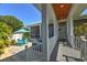 Inviting outdoor porch area with a hot tub, lounge area, and scenic backyard views at 329 W Grace St, Punta Gorda, FL 33950