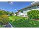 Lush backyard with manicured lawn and beautiful landscaping surrounding the home's exterior at 329 W Grace St, Punta Gorda, FL 33950