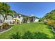 Expansive backyard featuring lush green lawn, landscaping, and a charming elephant statue at 329 W Grace St, Punta Gorda, FL 33950