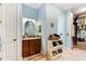 Charming bathroom featuring blue walls, tiled floors, and a view into the spacious walk-in closet at 329 W Grace St, Punta Gorda, FL 33950