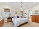Bright bedroom featuring a queen bed, neutral paint, and carpet floor at 329 W Grace St, Punta Gorda, FL 33950