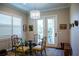 Cozy dining area with a glass table, designer chandelier, and sliding doors leading to the outdoors at 329 W Grace St, Punta Gorda, FL 33950
