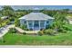 Charming exterior elevation showcasing the home's curb appeal, porch, and beautifully landscaped front yard at 329 W Grace St, Punta Gorda, FL 33950
