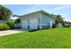 Exterior view of a two-car garage with a well-manicured lawn and appealing curb appeal at 329 W Grace St, Punta Gorda, FL 33950